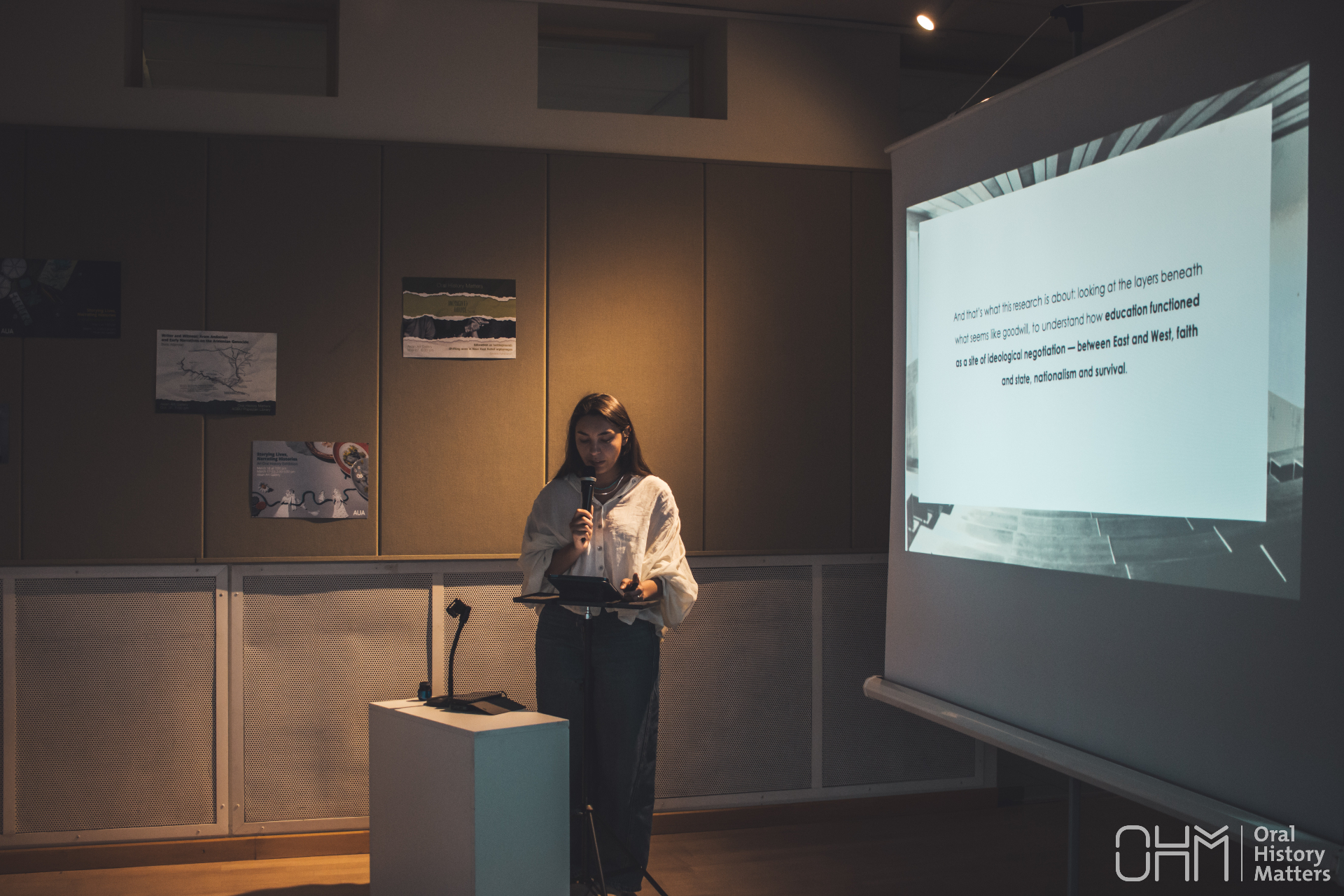 Gayane presenting research with a microphone