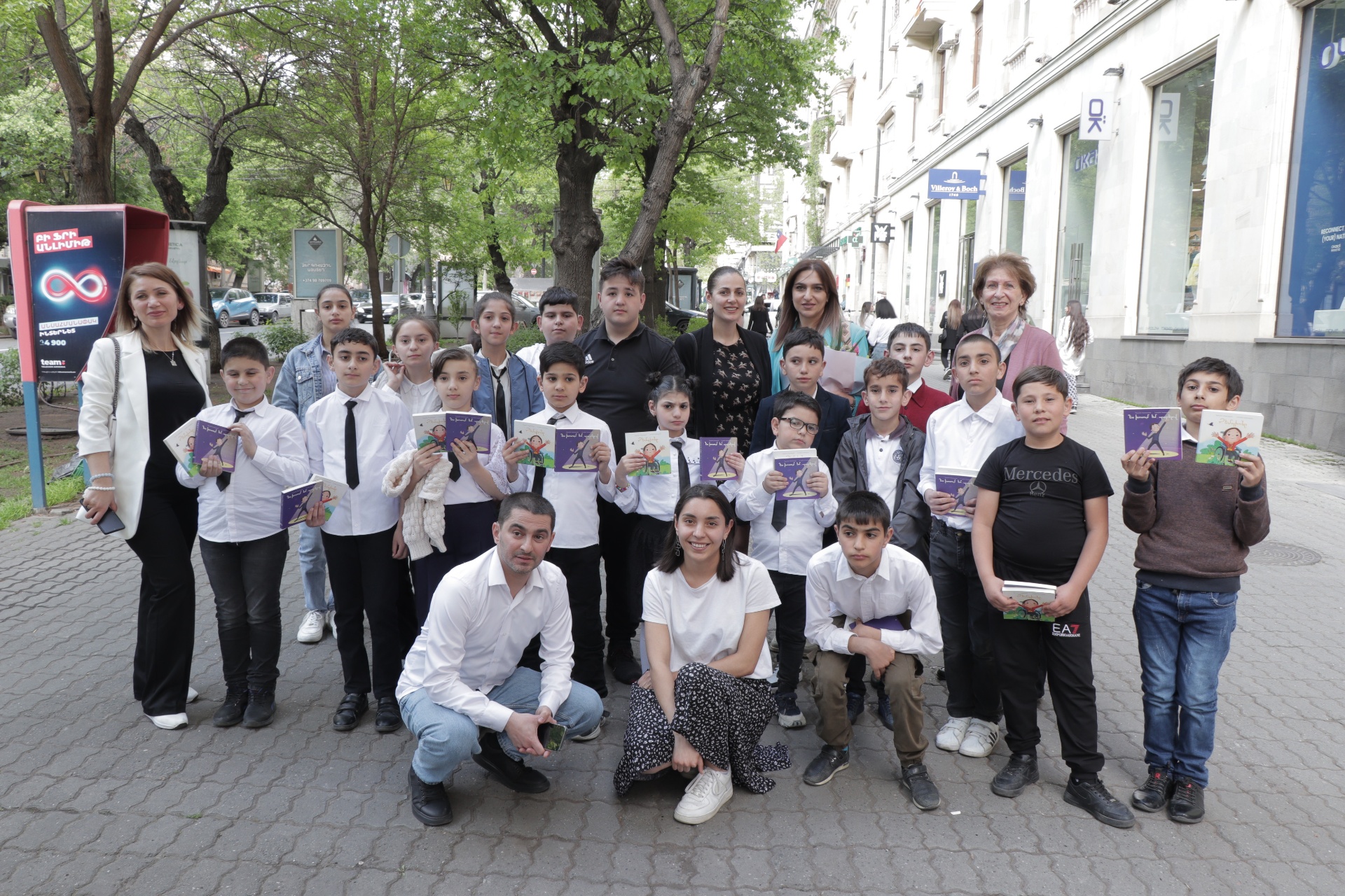 A large group of children in Yerevan holding copies of the books